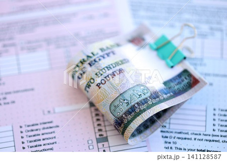 Egyptian pound money bills on tax form. Taxation and accounting concept Egyptian pound money bills on tax form. Taxation and accounting concept 141128587