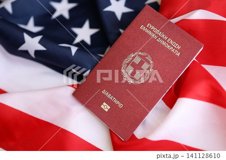 Greece passport on big waving flag of United States of America. US Visa and immigration 141128610
