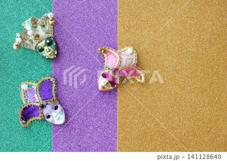 A group of venetian, mardi gras mask or disguise on a colorful glitter background A group of venetian, mardi gras mask or disguise on a colorful glitter background 141128640