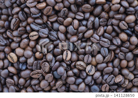 Close-up of roasted Arabica coffee beans. Background of brown roasted beans Close-up of roasted Arabica coffee beans. Background of brown roasted beans 141128650