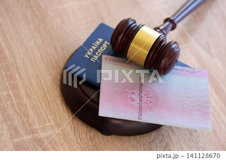 German temporary Permanent resident card and Ukrainian passport lies with judge hammer German temporary Permanent resident card and Ukrainian passport lies with judge hammer 141128670