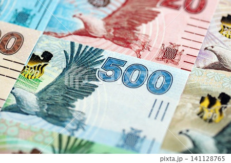Zambian kwacha money bills pile on table. Zambia banknotes of ZMW currency close up 141128765