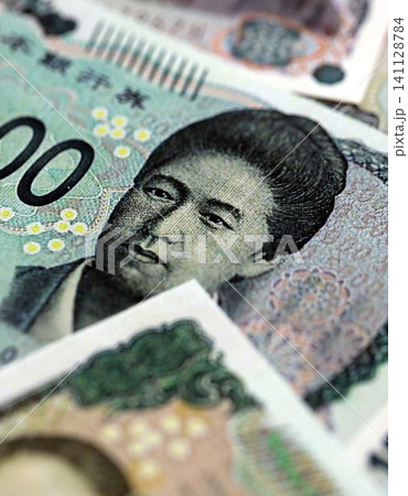 Japanese yen money bills pile on table. Japan banknotes of JPY currency close up Japanese yen money bills pile on table. Japan banknotes of JPY currency close up 141128784