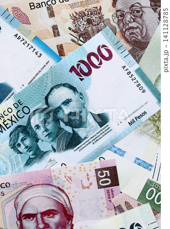 Mexican peso money bills pile on table. Mexico banknotes of MXN currency. Concept of business 141128785