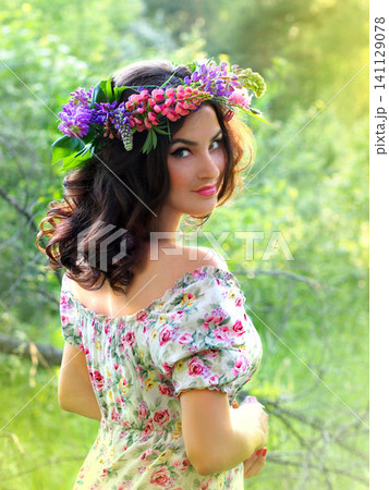 A girl with a wreath of wildflowers, a portrait in the forest. Forest landscape. Summer mood, vertical photo A girl with a wreath of wildflowers, a portrait in the forest. Forest landscape. Summer mood, vertical photo 141129078
