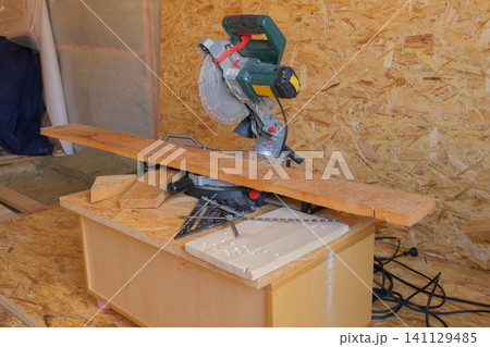 Retro vintage workshop. Circular Saw Industrial workplace manual vocation skills concept. Woodworking. Desktop for pine board cuts. Carpenter tools background. Old joinery table with furniture details 141129485