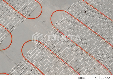 Electric Heating Mat Installing in the Tile Adhesive. Underfloor Dual Core Fiberglass Mesh Mat. Warm Floor Heating System. Warming. Worker Applying Concrete Mortar for Warm Floor. Renovation work. 4K Electric Heating Mat Installing in the Tile Adhesive. Underfloor Dual Core Fiberglass Mesh Mat. Warm Floor Heating System. Warming. Worker Applying Concrete Mortar for Warm Floor. Renovation work. 4K 141129722