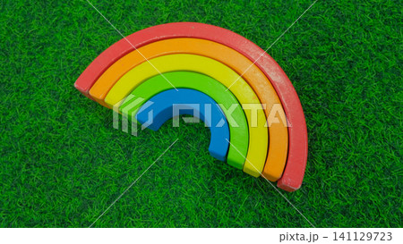 Eco friendly wooden rainbow toy for early childhood development. Concept of a children's store of educational toys. Wooden Stacking Rainbow Toy for creativity. Children's waldorf or montessori school. Eco friendly wooden rainbow toy for early childhood development. Concept of a children's store of educational toys. Wooden Stacking Rainbow Toy for creativity. Children's waldorf or montessori school. 141129723