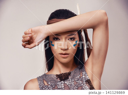 Portrait, woman and Native American girl in studio with warrior makeup, confidence and tribe style. Indigenous fashion, face paint and model in First Nations clothes on white background with culture 141129869