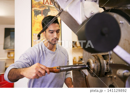 Man, factory and machine for grinding coffee with roast, process and flavor for export in industry. Person, employee and tools for caffeine, beans or press with manufacturing at warehouse in Colombia Man, factory and machine for grinding coffee with roast, process and flavor for export in industry. Person, employee and tools for caffeine, beans or press with manufacturing at warehouse in Colombia 141129892