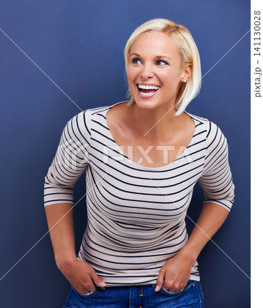 Woman, smile and relax confidence in studio with fashion outfit on blue background, good mood or mockup space. Female person, happiness and laughing in Australia for positivity, cheerful or carefree 141130028