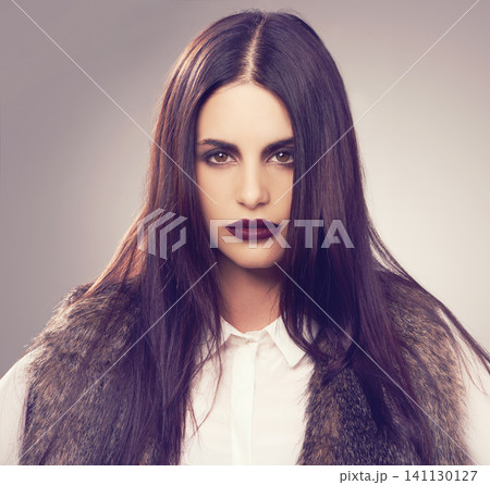 Studio, model and portrait with cosmetics, fur and beauty for natural proud attitude. Woman, fashion and clothes for confidence, glamour and elegance for chic fashionista isolated on white background 141130127