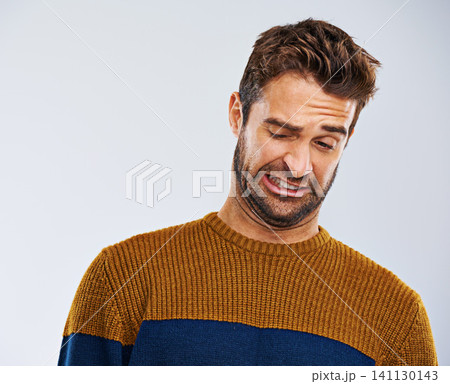 Man, frown and facial expression in studio for disgust and regret for attitude, emotion and mood. Male model and young person and isolated with face gesture or grimace for oops on white background Man, frown and facial expression in studio for disgust and regret for attitude, emotion and mood. Male model and young person and isolated with face gesture or grimace for oops on white background 141130143