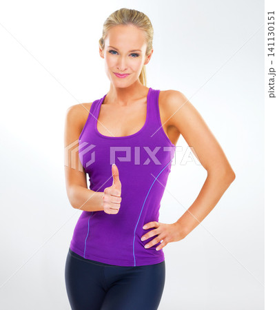 Woman, portrait and wellness in studio with thumbs up for healthy lifestyle, fitness and ready to exercise. Athlete, person and smile with sportswear for workout and hand gesture on white background Woman, portrait and wellness in studio with thumbs up for healthy lifestyle, fitness and ready to exercise. Athlete, person and smile with sportswear for workout and hand gesture on white background 141130151