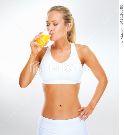 Studio, drink and portrait of woman with orange juice for health, vitamin c or weight loss. Underwear, glass and person with citrus beverage for wellness, nutrition or diet on white background 141130309
