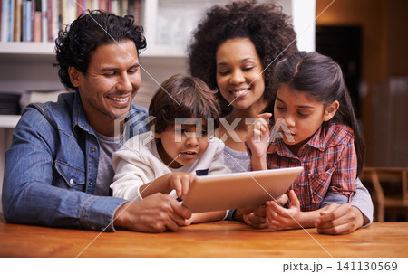 Family, children and table with tablet for educational games on online website for child development. Parents, home and siblings for bonding in living room with cartoons for learning and growth Family, children and table with tablet for educational games on online website for child development. Parents, home and siblings for bonding in living room with cartoons for learning and growth 141130569