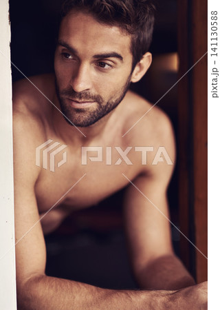Closeup, shirtless or guy to relax, thinking or memory of planning, break or idea as dream vacation. Man, window or vision of summer, holiday or rest to imagine, future or recreation in home 141130588