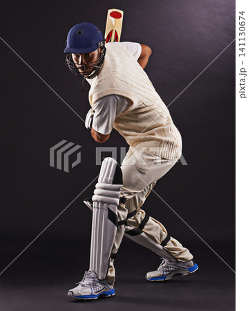 Man, cricket and athlete with sports bat in studio for professional match, competition or black background. Male person, gear and helmet with mockup space or fitness training, performance or game Man, cricket and athlete with sports bat in studio for professional match, competition or black background. Male person, gear and helmet with mockup space or fitness training, performance or game 141130674