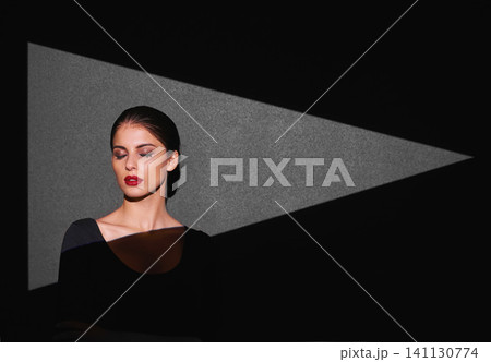 Beauty, art and woman with light of triangle, shape or serious isolated on gray background. Female person, lady or spotlight on face for cosmetics, skincare or makeup by mockup on studio backdrop Beauty, art and woman with light of triangle, shape or serious isolated on gray background. Female person, lady or spotlight on face for cosmetics, skincare or makeup by mockup on studio backdrop 141130774