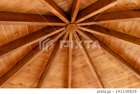Geometric structure of supporting beams inside a wooden cottage with a round roof Geometric structure of supporting beams inside a wooden cottage with a round roof 141130829