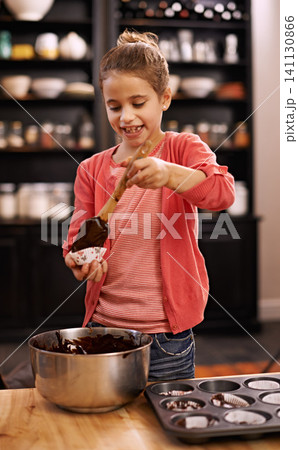 Girl, baking and learning with kid, smile and ingredients with utensils and child development with dessert. Home, apartment or kitchen with recipe and prepare with food or cupcake with joy or mixture 141130866