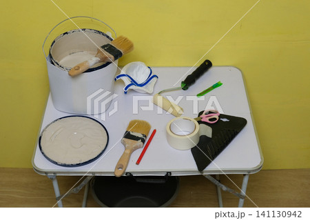 Painter equipment. Commercial house painter workspace. Wall painting setup with paint jar, brushes and assorted decorating tools. Home Improvement project Setting. Paint bucket and various rollers. Painter equipment. Commercial house painter workspace. Wall painting setup with paint jar, brushes and assorted decorating tools. Home Improvement project Setting. Paint bucket and various rollers. 141130942