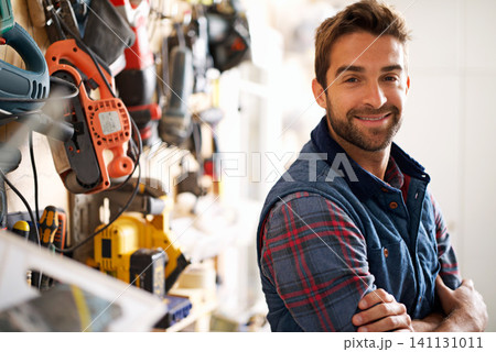 Smile, carpenter and portrait of man in garage for production, manufacturing or small business. Male person, tools and handyman with equipment for renovation, remodeling or maintenance in workshop 141131011
