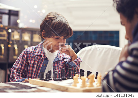 Child, father and chess game with thinking strategy or checkmate move with knight, king or queen. Son, parent and board for competition learn or decision thoughts for play, contest or problem solving Child, father and chess game with thinking strategy or checkmate move with knight, king or queen. Son, parent and board for competition learn or decision thoughts for play, contest or problem solving 141131045