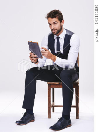 Studio, portrait and man with chair, tablet and business for style and fashion. Professional, lawyer or attorney with corporate, technology and consultant with suit isolated on white background Studio, portrait and man with chair, tablet and business for style and fashion. Professional, lawyer or attorney with corporate, technology and consultant with suit isolated on white background 141131089
