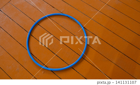 Gymnastics hoop. Physical education. Fitness, Dieting, healthy lifestyle Concept, Sport Item exercise accessories. Lockers in gym locker room background. Copy space. Indoor workout. Wellness exercise. Gymnastics hoop. Physical education. Fitness, Dieting, healthy lifestyle Concept, Sport Item exercise accessories. Lockers in gym locker room background. Copy space. Indoor workout. Wellness exercise. 141131107