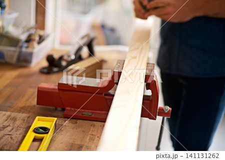 Carpentry, craft and workbench with wood for home improvement, building renovation and woodwork in garage. Lumber, construction and person for diy, furniture restoration or manufacturing on project Carpentry, craft and workbench with wood for home improvement, building renovation and woodwork in garage. Lumber, construction and person for diy, furniture restoration or manufacturing on project 141131262