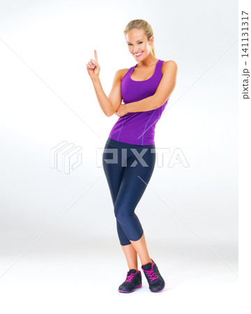 Woman, portrait and workout clothes in studio with finger for routine as strong athlete, lose weight or white background. Female person, face and confidence for fitness performance, pilates or mockup Woman, portrait and workout clothes in studio with finger for routine as strong athlete, lose weight or white background. Female person, face and confidence for fitness performance, pilates or mockup 141131317
