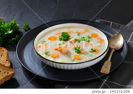 Soup with Chunky Potatoes and Carrots in a bowl 141132109