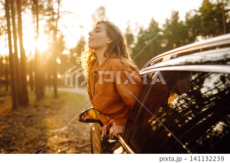 A traveler enjoys a sunny day from the car window. Travel concept. Active lifestyle. 141132239