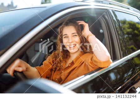 Emotional woman drives a car. The concept of fast movement, traveling by car. 141132244