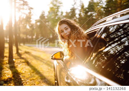 A traveler enjoys a sunny day from the car window. Travel concept. Active lifestyle. A traveler enjoys a sunny day from the car window. Travel concept. Active lifestyle. 141132268