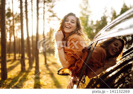 A traveler enjoys a sunny day from the car window. Travel concept. Active lifestyle. A traveler enjoys a sunny day from the car window. Travel concept. Active lifestyle. 141132269