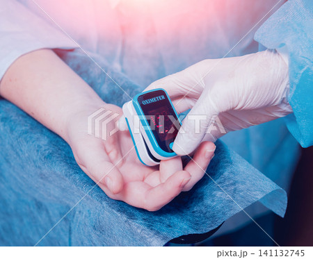 Pulse oximeter on the patient's hand Pulse oximeter on the patient's hand 141132745