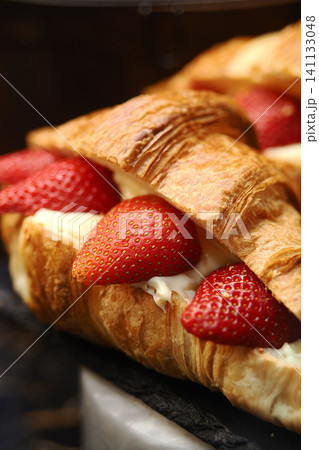 Croissant filled with strawberries and creamy delight Croissant filled with strawberries and creamy delight 141133048