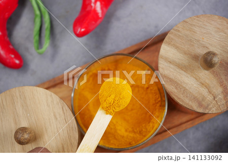 Vibrant spices on display in a colorful kitchen scene 141133092