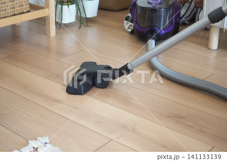 Vacuuming the living room in the afternoon Vacuuming the living room in the afternoon 141133139