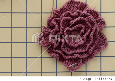 Crochet rose flower close-up isolated on white background Crochet rose flower close-up isolated on white background 141133273