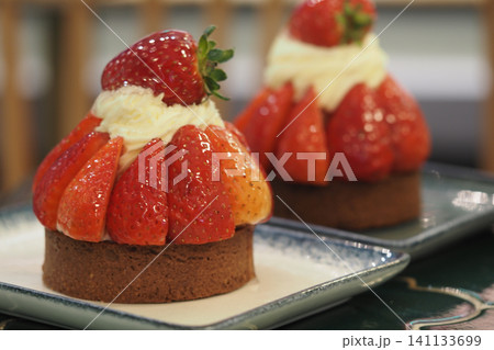 Strawberry dessert on a plate in a cafe setting Strawberry dessert on a plate in a cafe setting 141133699