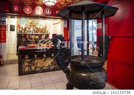 Bronze incense burner with dragon carvings inside a traditional Taiwanese temple shrine Bronze incense burner with dragon carvings inside a traditional Taiwanese temple shrine 141133736