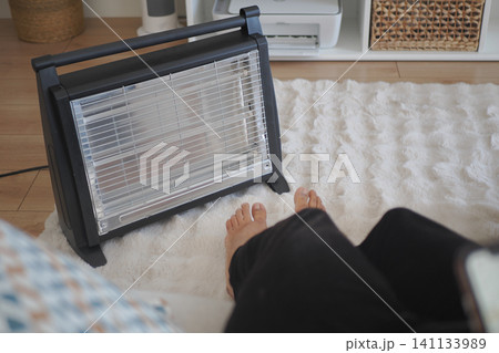 Warm feet near a heater on a winter day at home Warm feet near a heater on a winter day at home 141133989