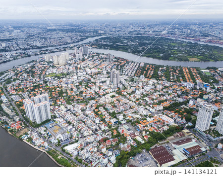 High-angle drone view of Thao Dien district and Saigon River in Ho Chi Minh City, Vietnam. 141134121
