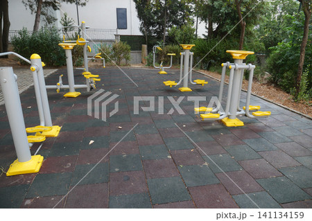 Community outdoor fitness area with exercise gear Community outdoor fitness area with exercise gear 141134159