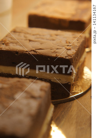 Delicious chocolate dessert squares on a wooden table Delicious chocolate dessert squares on a wooden table 141134167