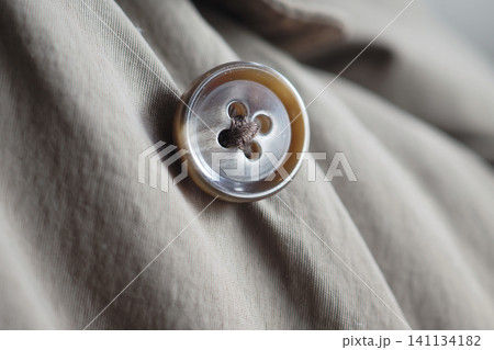 Close up of a button on a piece of clothing Close up of a button on a piece of clothing 141134182