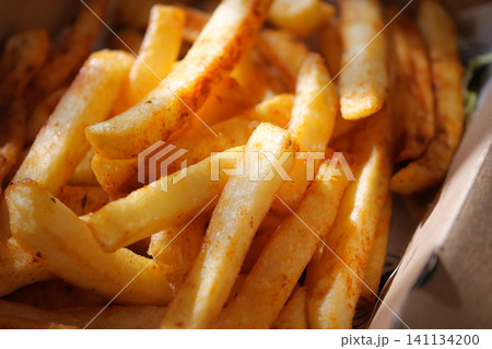 Crispy golden fries served in a fast food container Crispy golden fries served in a fast food container 141134200